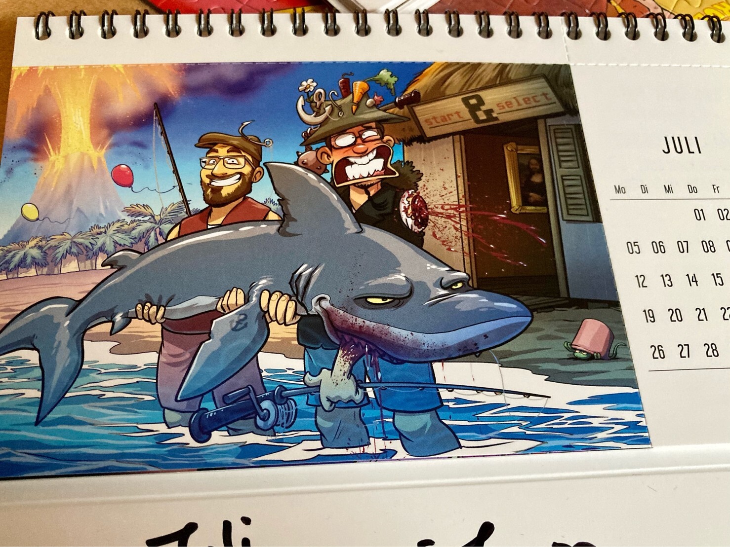 Zeichnung mit Joachim Hesse und mir im Gronkh Jahreskalender. Wir halten einen riesigen Hai in den Armen und Jo wurde ein Arm abgebissen.