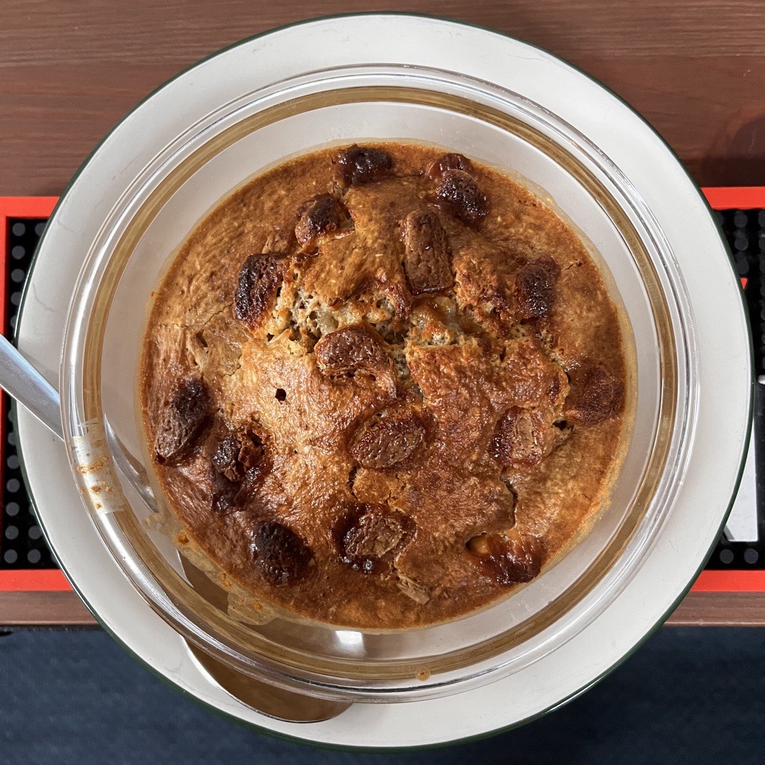 Ein Teller gebackenes Porridge mit Stücken von weißer Schokolade.